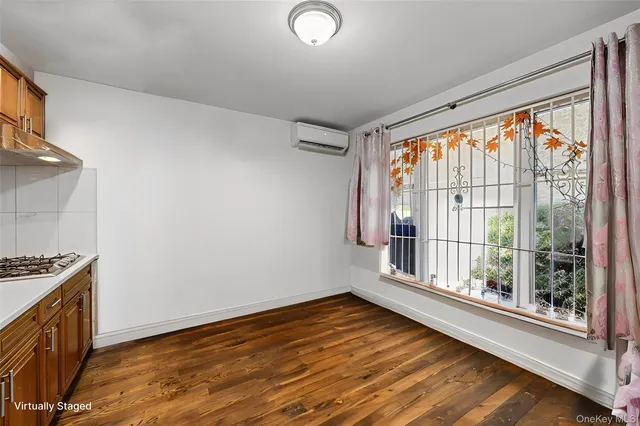 a view of wooden floor and windows in a room