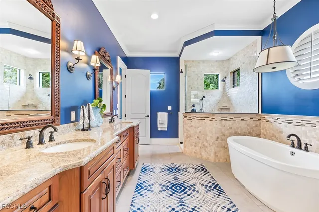 a spacious bathroom with a granite countertop double vanity sink and a mirror