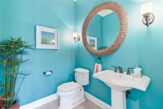 a bathroom with a sink mirror and toilet