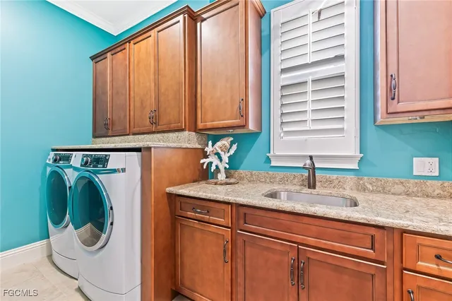 a kitchen with a sink a washer and dryer next to a window