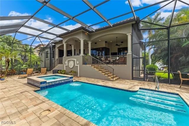 a view of a house with backyard and sitting area
