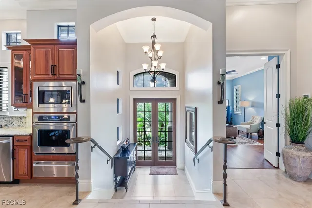 a living room with fireplace furniture and a chandelier