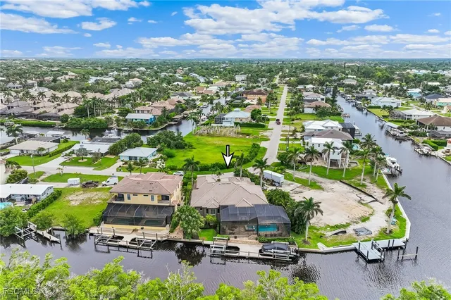 an aerial view of a house with a swimming pool a yard and mountain view