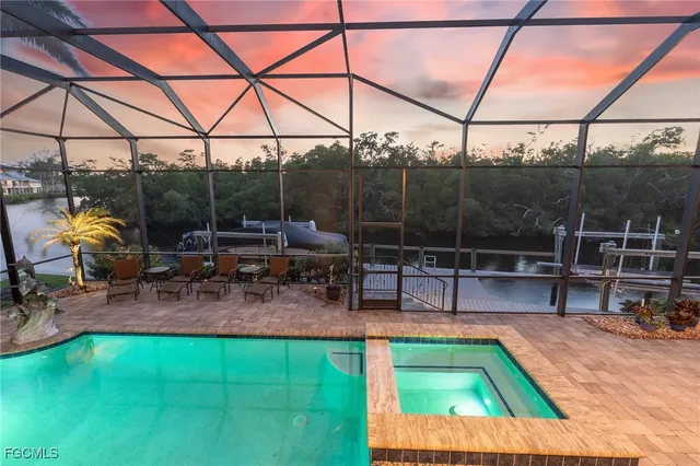 a view of a swimming pool with a patio and a yard