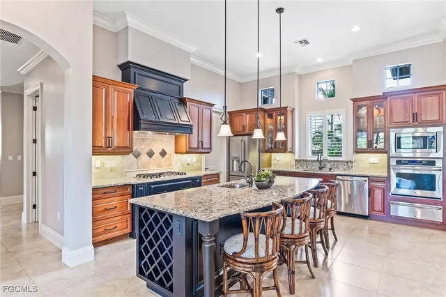 a kitchen with granite countertop a table chairs stove and cabinets