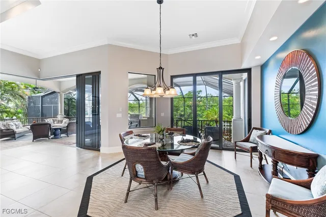a dining room with furniture a chandelier and pool table