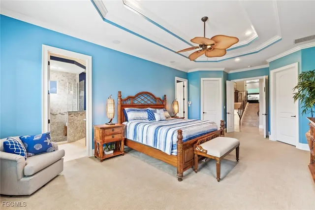 a bedroom with a bed and chandelier