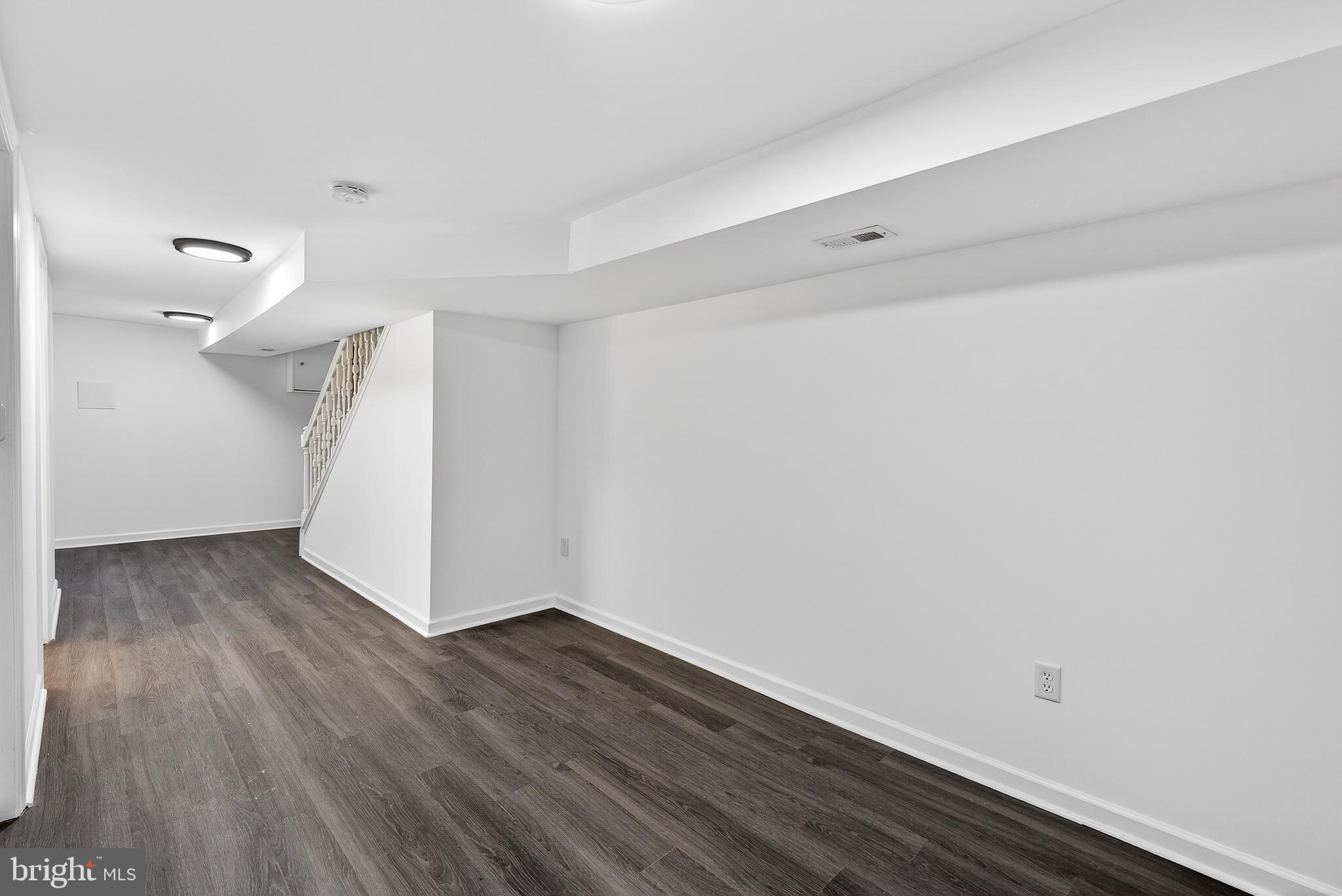 7014 Belclare Road Baltimore, MD 21222 - Photo 21 of 36 a view of an empty room with wooden floor and a window