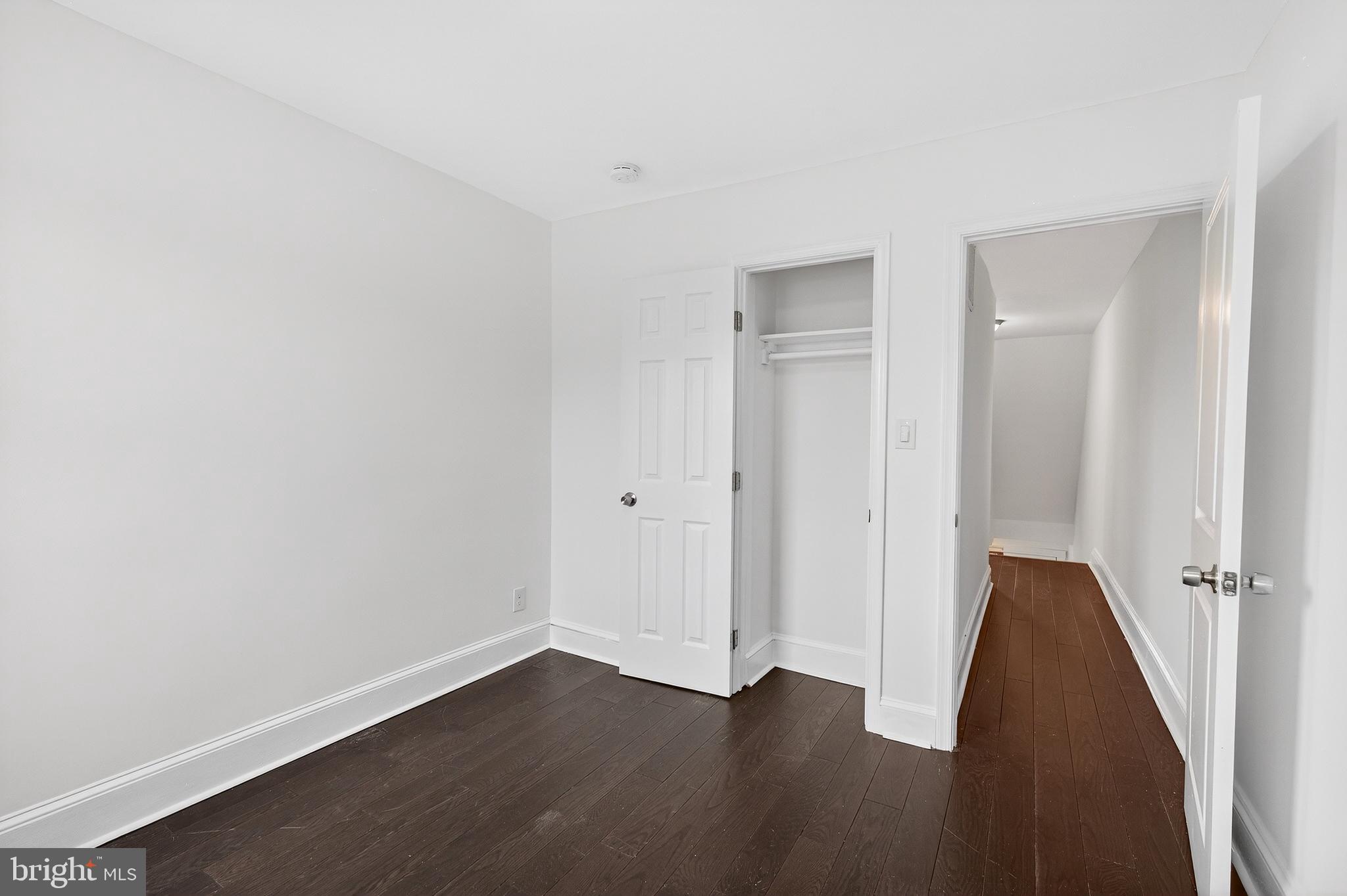 7014 Belclare Road Baltimore, MD 21222 - Photo 23 of 36 an empty room with wooden floor and closet
