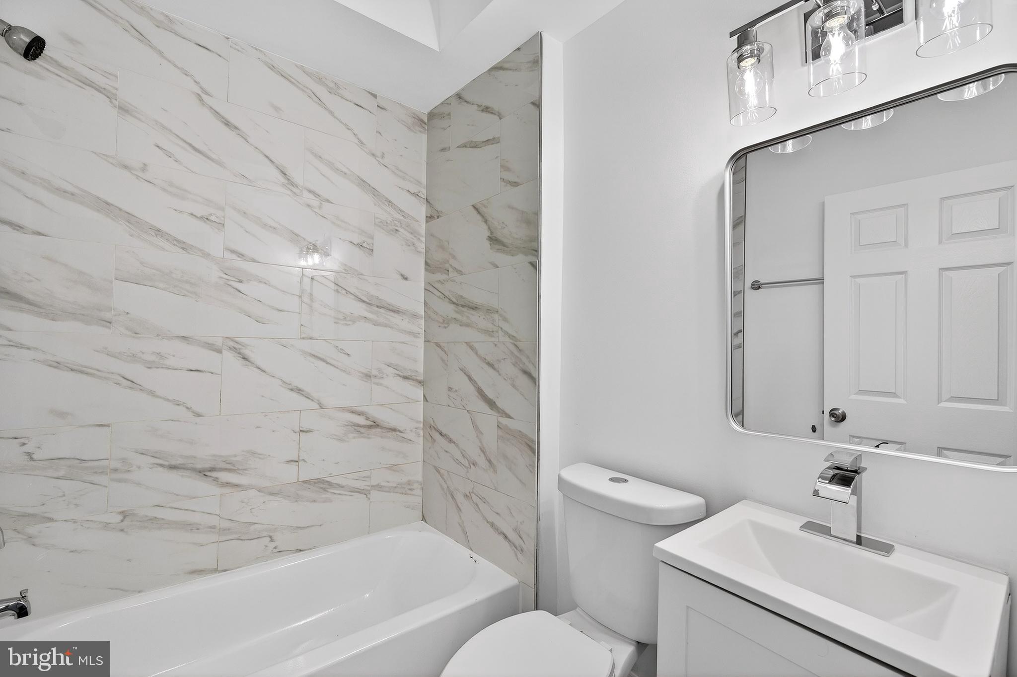 7014 Belclare Road Baltimore, MD 21222 - Photo 26 of 36 a bathroom with a sink toilet and shower