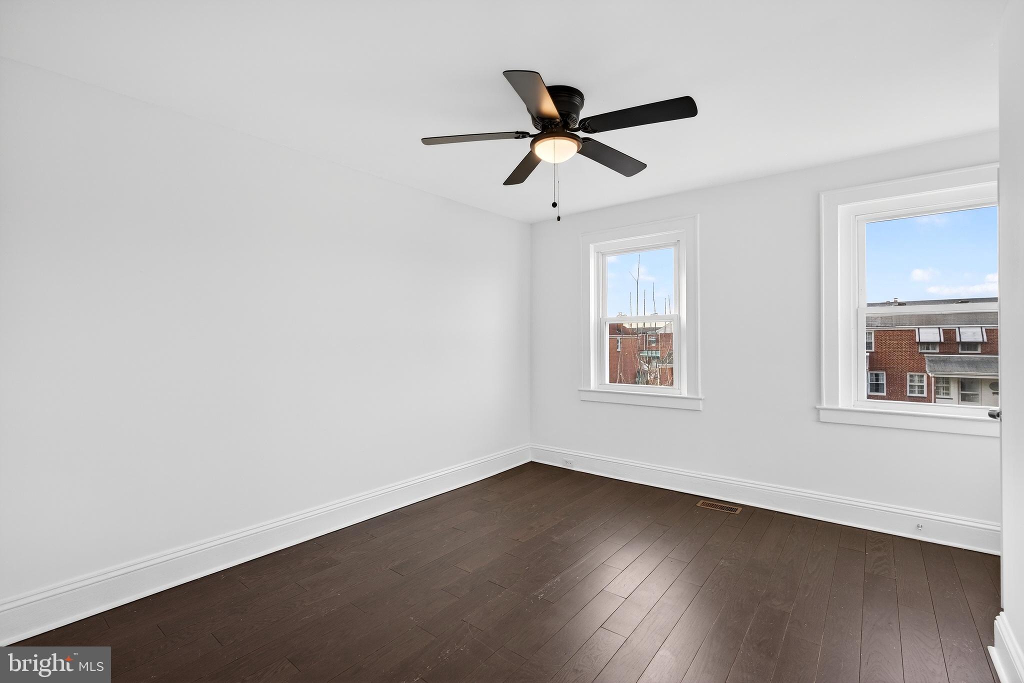7014 Belclare Road Baltimore, MD 21222 - Photo 28 of 36 a view of empty room with wooden floor and fan