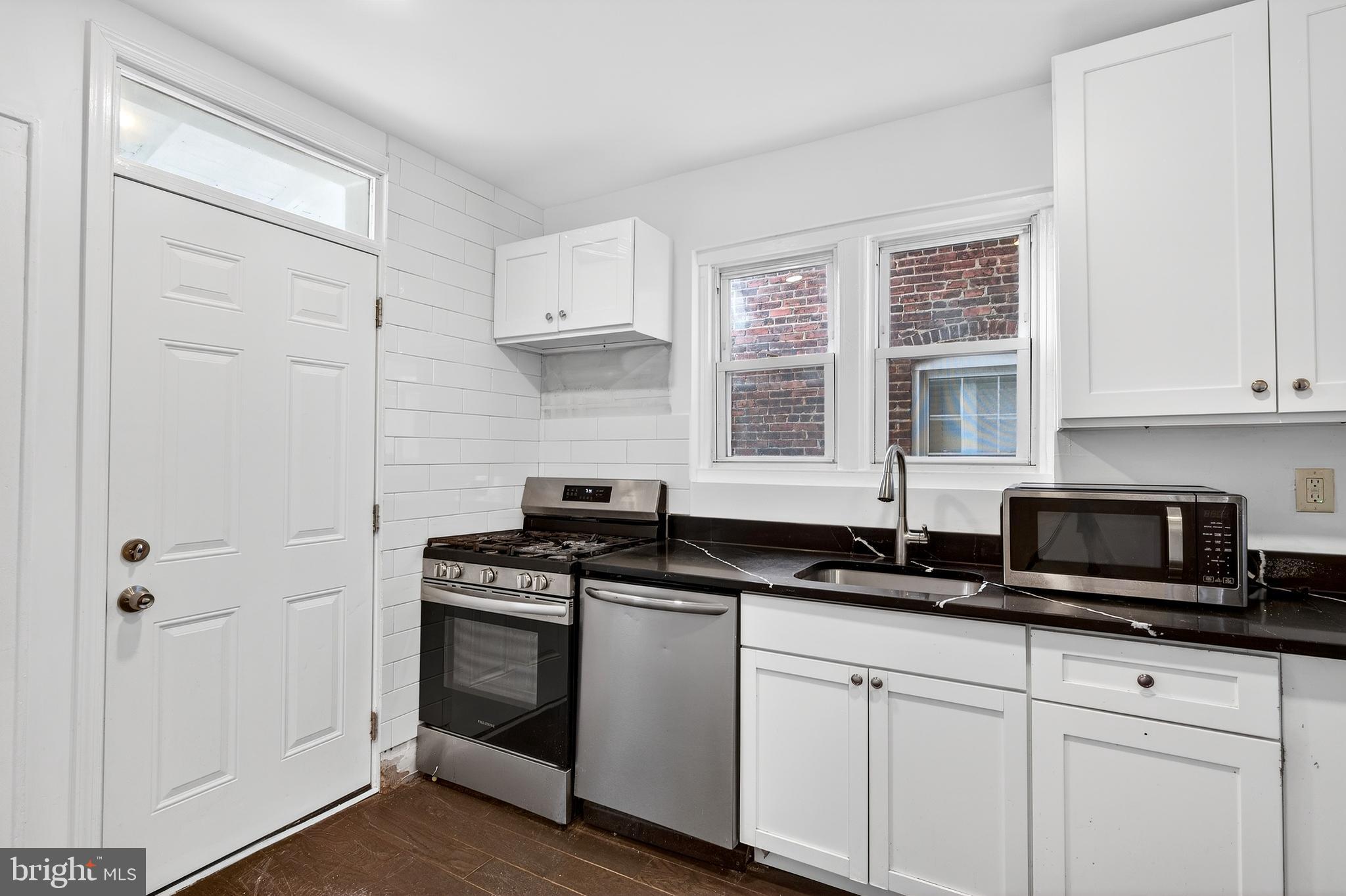 7014 Belclare Road Baltimore, MD 21222 - Photo 3 of 36 a kitchen with stainless steel appliances granite countertop a sink a stove and a granite counter tops