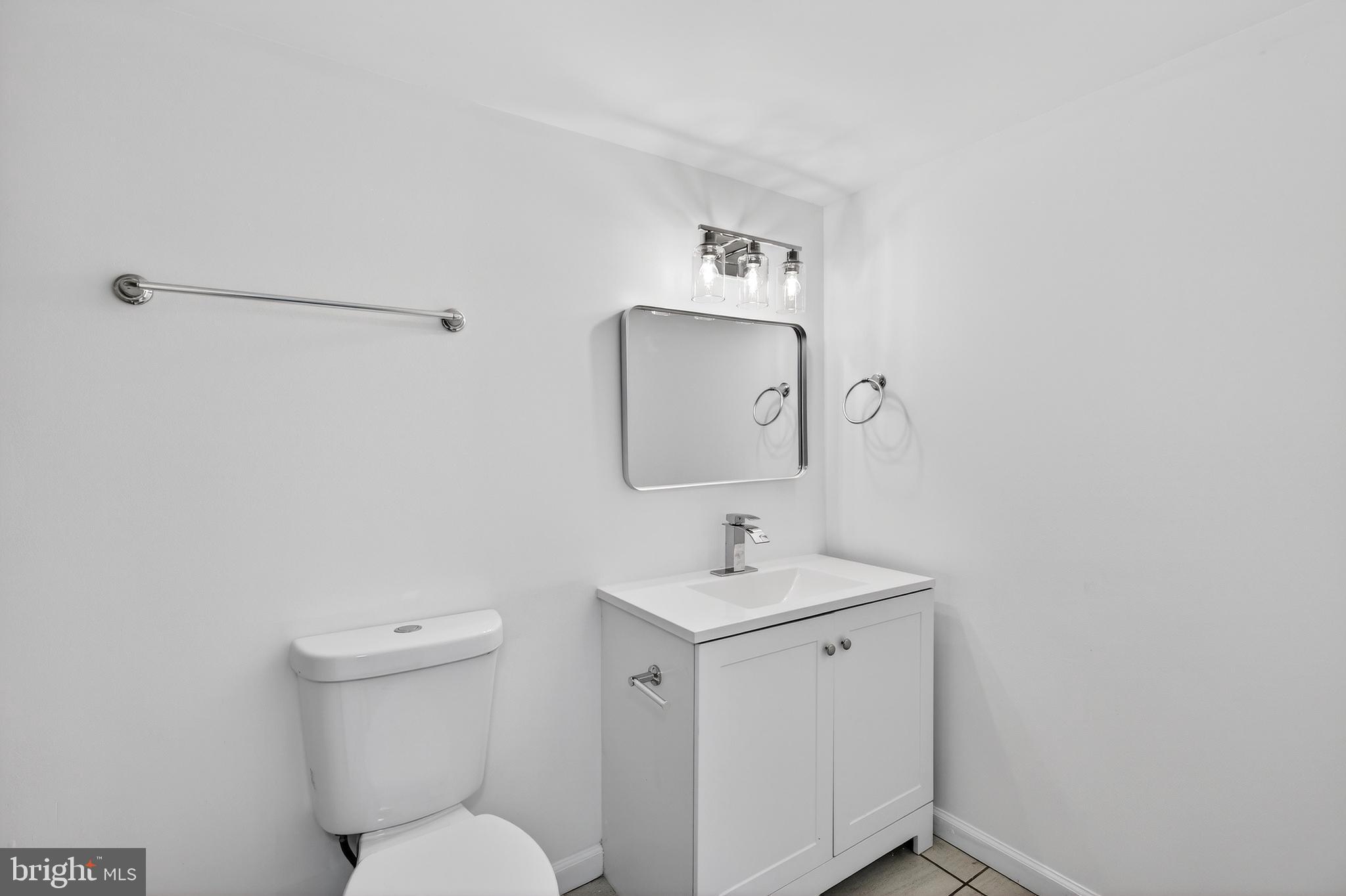 7014 Belclare Road Baltimore, MD 21222 - Photo 9 of 36 a bathroom with a toilet sink and mirror