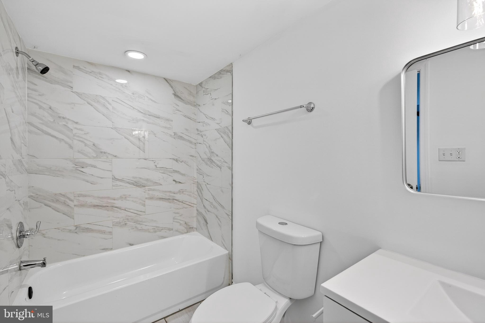 7014 Belclare Road Baltimore, MD 21222 - Photo 10 of 36 a bathroom with a toilet and a bathtub