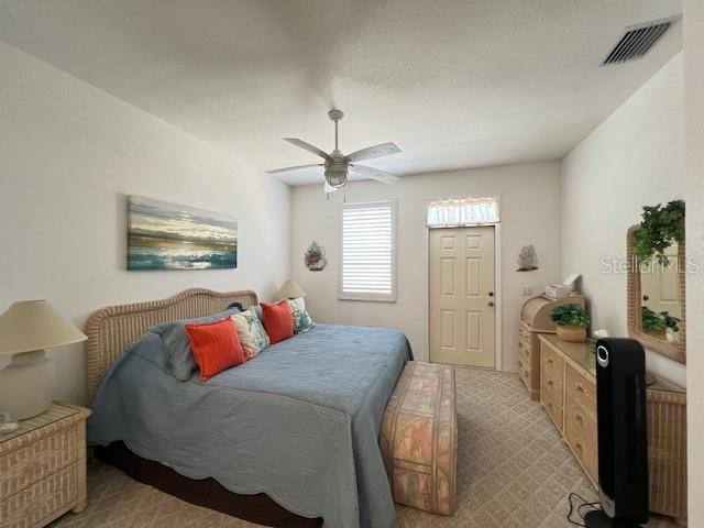 3181 Matecumbe Key Road, Unit 10 Punta Gorda, FL 33955 - Photo 18 of 52 a bedroom with a bed a couch and dresser