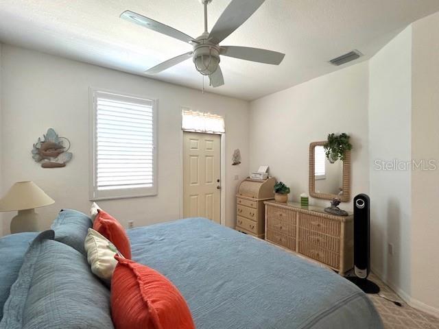 3181 Matecumbe Key Road, Unit 10 Punta Gorda, FL 33955 - Photo 19 of 52 a bedroom with a bed and a chandelier