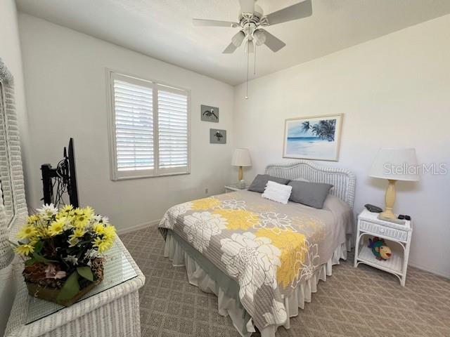3181 Matecumbe Key Road, Unit 10 Punta Gorda, FL 33955 - Photo 21 of 52 a bedroom with a bed and a chandelier