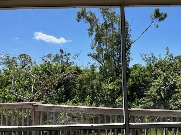 a view of a balcony with a tree