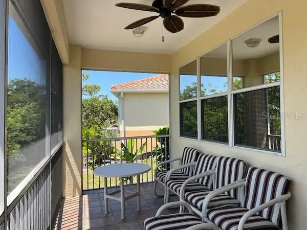 a view of a porch with furniture and a window