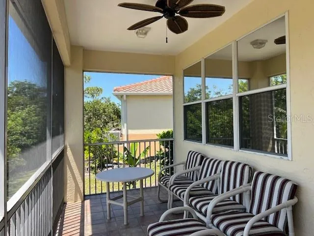 a view of a porch with furniture and a window