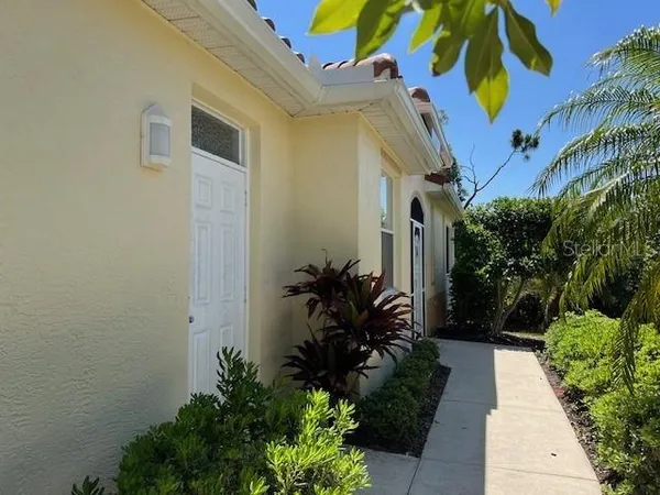 a view of a house with potted plants