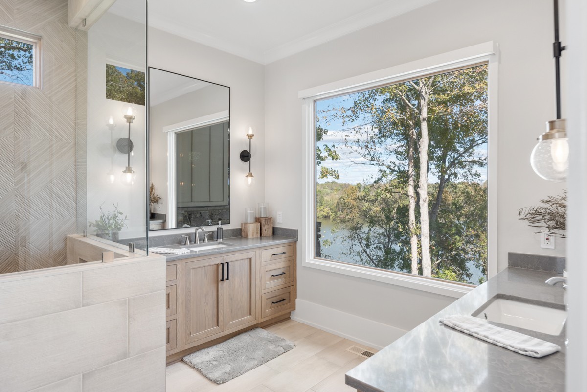 5893 Cairo Bend Road Lebanon, TN 37087 - Photo 19 of 47 a spacious bathroom with a double vanity sink large mirror and a large window