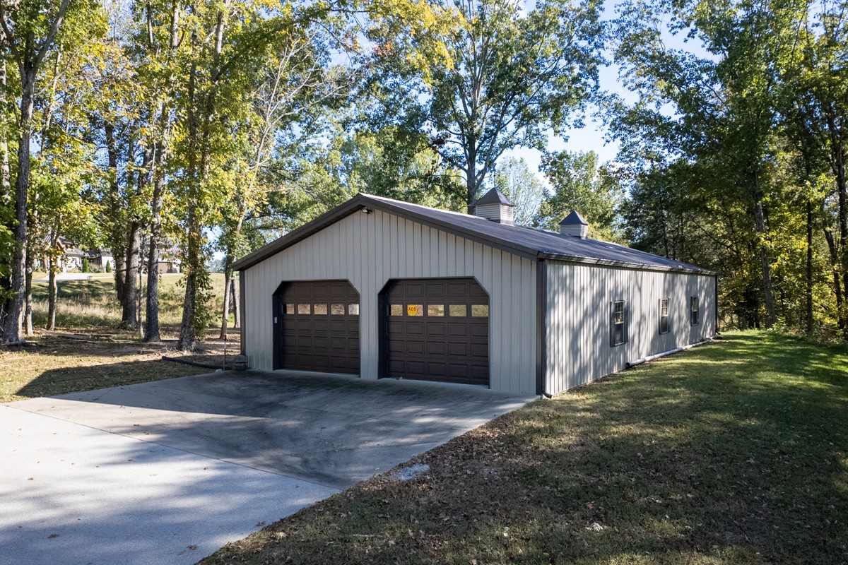 5893 Cairo Bend Road Lebanon, TN 37087 - Photo 43 of 47 a front view of a house with a yard and garage