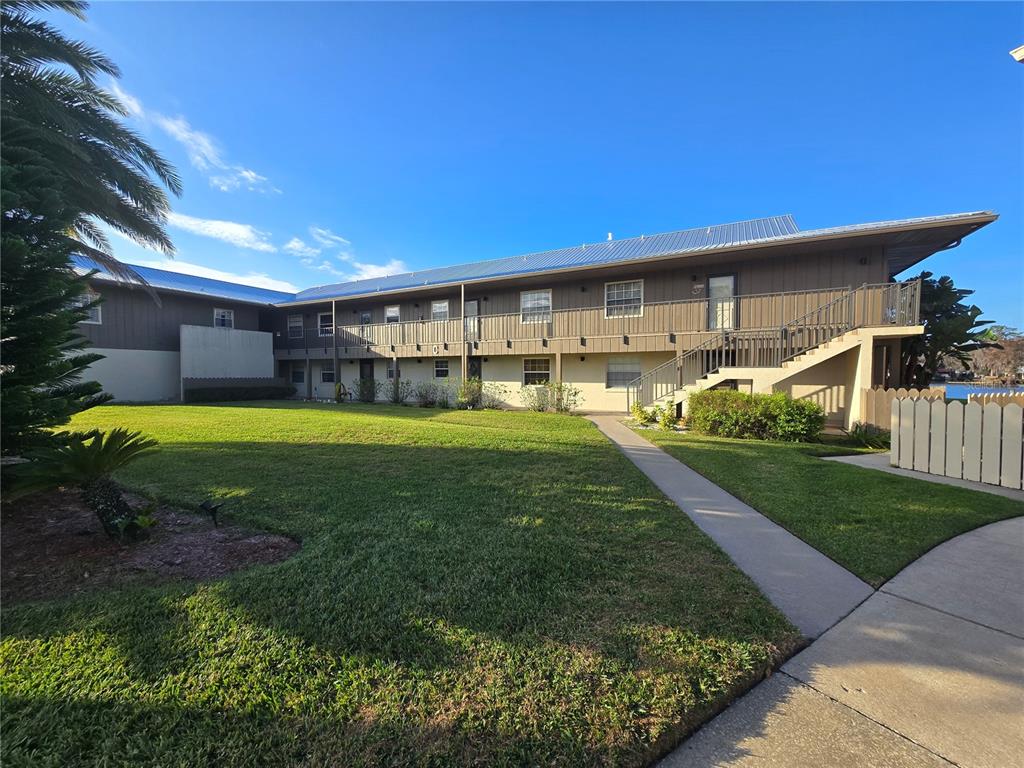 a view of a house with a yard porch and sitting area