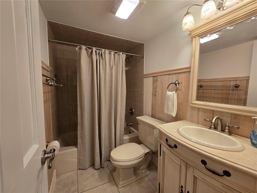 1640 Juno Trail, Unit 103C Astor, FL 32102 - Photo 14 of 20 a bathroom with a sink toilet and shower