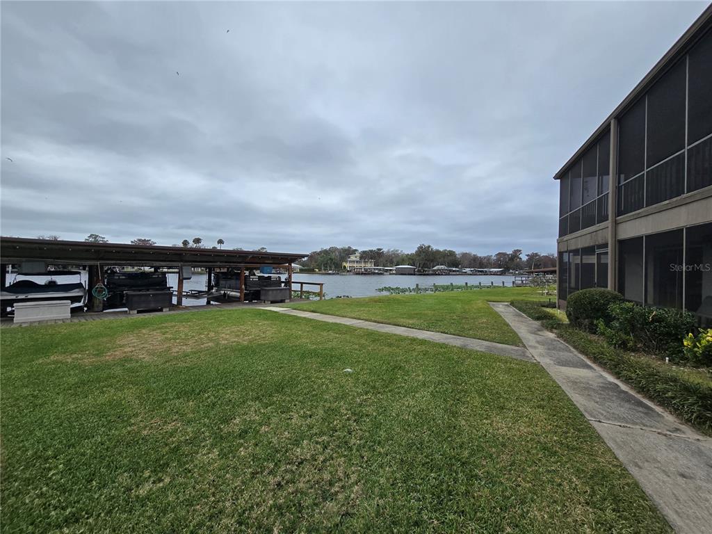 1640 Juno Trail, Unit 103C Astor, FL 32102 - Photo 19 of 20 a view of a big house with a big yard and large trees