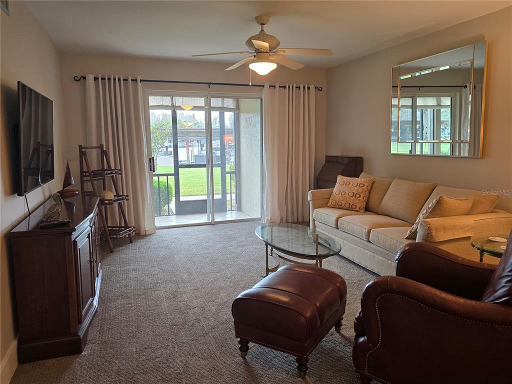 1640 Juno Trail, Unit 103C Astor, FL 32102 - Photo 3 of 20 a living room with furniture and a flat screen tv