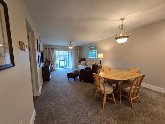 a view of a dining room with furniture and a chandelier