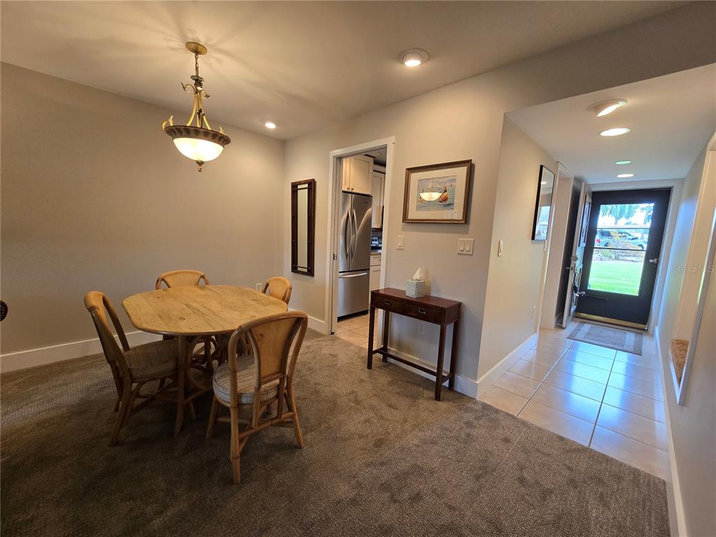 1640 Juno Trail, Unit 103C Astor, FL 32102 - Photo 6 of 20 a view of a dining room with furniture