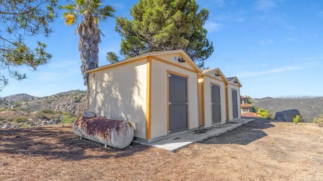 an aerial view of residential house and mountains in the background