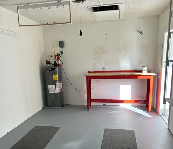 a view of a kitchen with a sink a ceiling fan and refrigerator