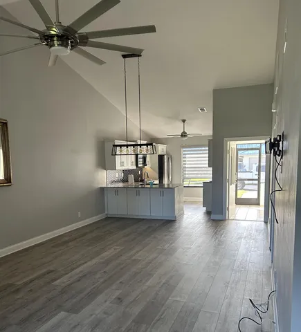 a kitchen with stainless steel appliances kitchen island wooden floors cabinets and counter space