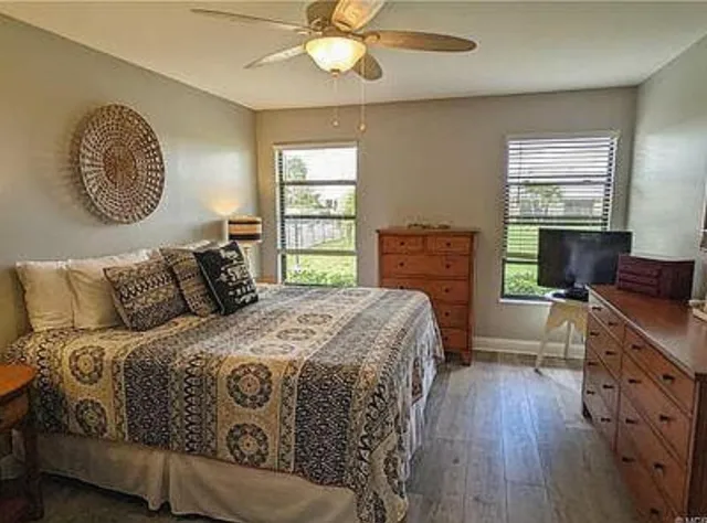 a kitchen with stainless steel appliances granite countertop a dining table chairs refrigerator and microwave