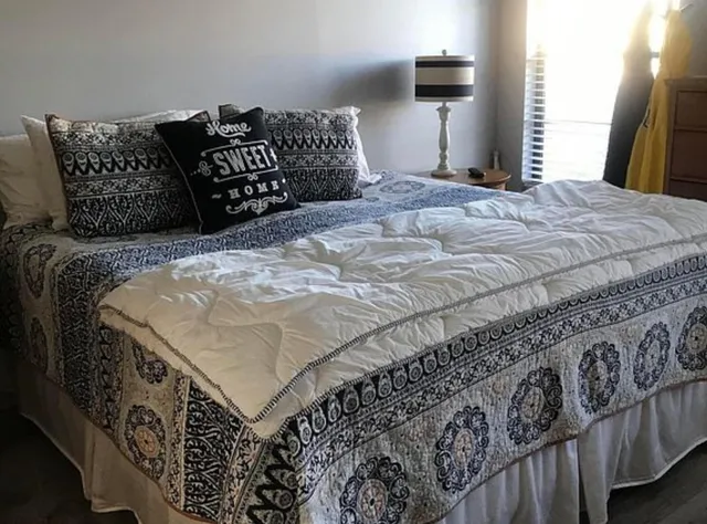 a kitchen with stainless steel appliances granite countertop a sink and a refrigerator