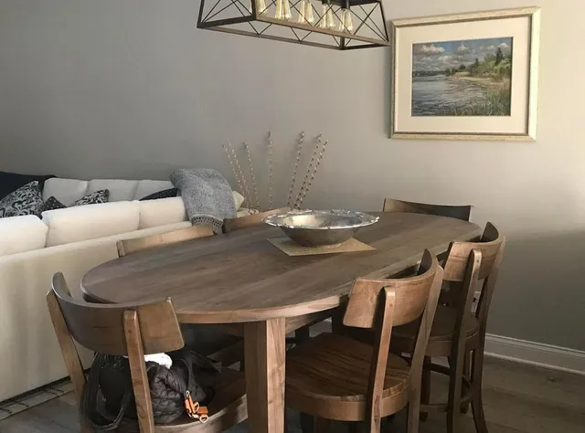 a hallway with table and a potted plant