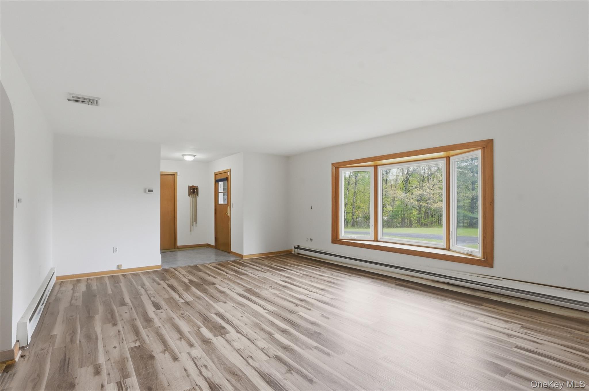 435 Samsonville Road Kerhonkson, NY 12446 - Photo 6 of 37 a view of an empty room with wooden floor and a window