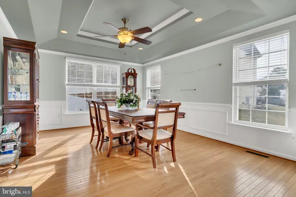 a view of a dining room with furniture and a chandelier