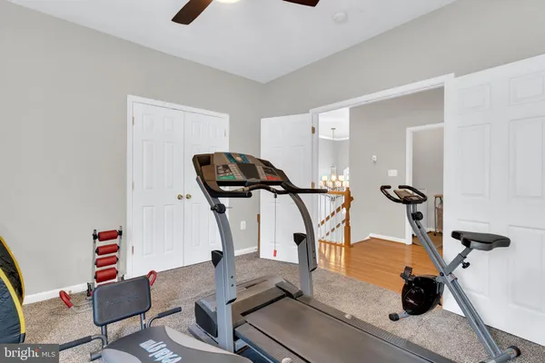 a living room with furniture a wall paintings and a window