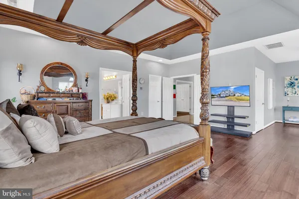 a view of house with yard outdoor seating and covered with trees