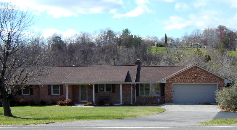 3051 Webster Road Blue Ridge, VA 24064 - Photo 1 of 39 a view of a white house next to a yard with large trees