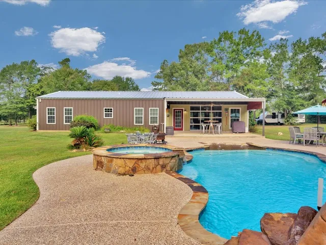 a view of house with a backyard space and garden view