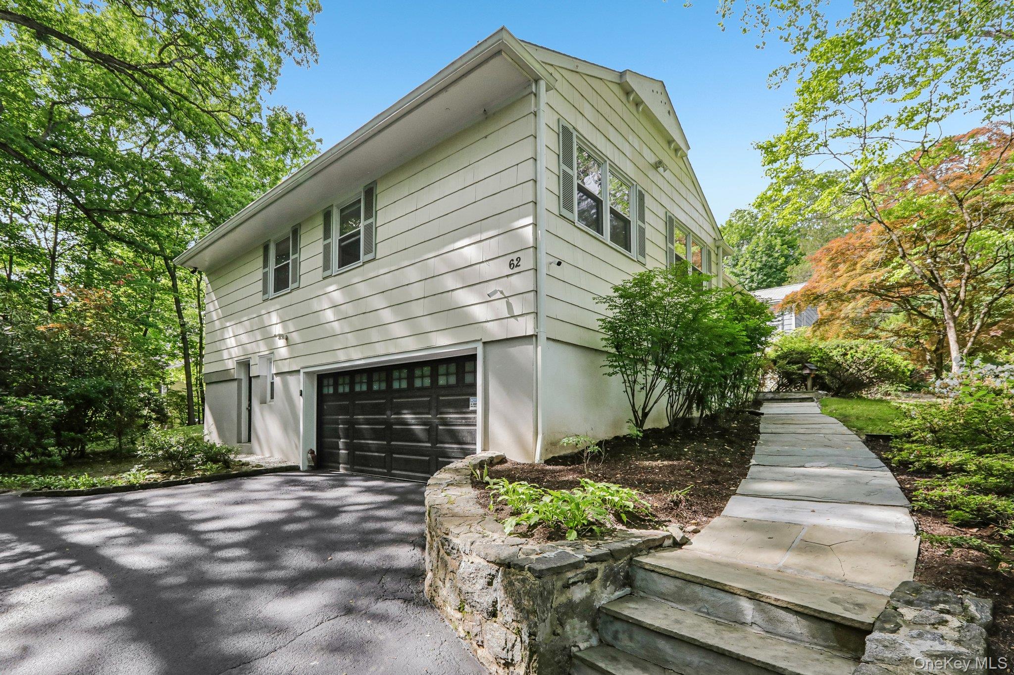 62 Mohegan Road Larchmont, NY 10538 - Photo 3 of 46 a front view of a house with a yard