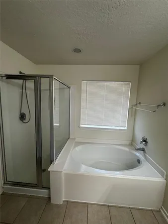a white bath tub sitting next to a shower