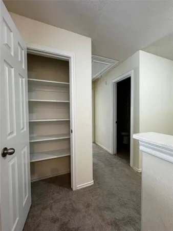 a view of an empty room with a closet