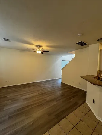 a view of a room with wooden floor