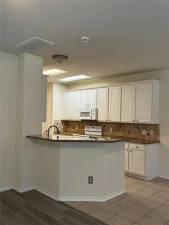 a kitchen with stainless steel appliances granite countertop a sink and cabinets